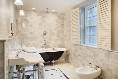Example of a mid-sized classic master gray tile, white tile and marble tile marble floor claw-foot bathtub design in Boston with a bidet, white walls and a wall-mount sink