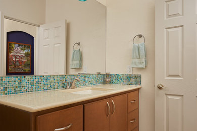 Пример оригинального дизайна: маленькая ванная комната в современном стиле с коричневыми фасадами, синей плиткой, стеклянной плиткой, бежевыми стенами, врезной раковиной, столешницей из искусственного кварца, бежевой столешницей, коричневым полом и шторкой для ванной для на участке и в саду