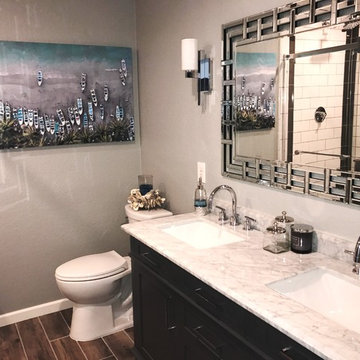 Beautiful gray vanity with marble countertop and dramatic mirror