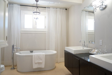 Design ideas for a medium sized contemporary ensuite bathroom in Toronto with a built-in sink, recessed-panel cabinets, white cabinets, a freestanding bath, an alcove shower, a one-piece toilet and white walls.