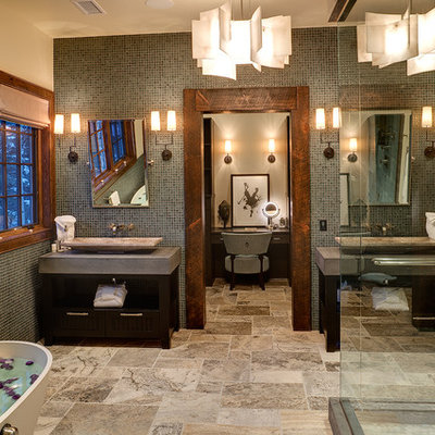 Example of a large trendy master mosaic tile and gray tile limestone floor and multicolored floor bathroom design in Denver with a vessel sink, flat-panel cabinets, dark wood cabinets, soapstone countertops and beige walls