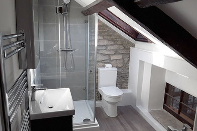 This is an example of a medium sized contemporary bathroom in Dorset with a hot tub, grey tiles, vinyl flooring, grey floors and a hinged door.