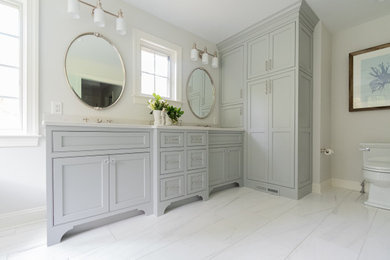 Bathroom - mid-sized traditional master white tile and marble tile marble floor and white floor bathroom idea in Philadelphia with beaded inset cabinets, gray cabinets, a one-piece toilet, gray walls, an undermount sink, quartzite countertops, a hinged shower door and white countertops