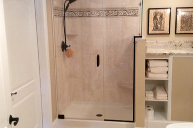 Alcove shower - large traditional beige tile porcelain tile alcove shower idea in Boston with an undermount sink, furniture-like cabinets, dark wood cabinets, granite countertops and beige walls