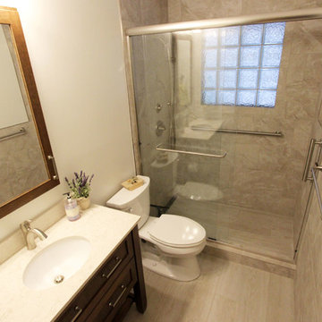 Beige Tiled Shower and Free Standing Vanity with Quartz Countertop