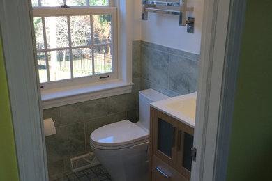 Small transitional master green tile and ceramic tile porcelain tile tub/shower combo photo in Philadelphia with a drop-in sink, glass-front cabinets, light wood cabinets, a one-piece toilet and white walls