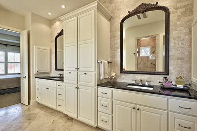 Example of a large master beige tile and stone tile travertine floor bathroom design in Austin with an undermount sink, white cabinets and granite countertops