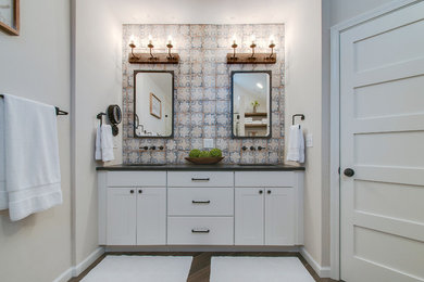 Mid-sized tuscan master white tile and ceramic tile ceramic tile and brown floor walk-in shower photo in Nashville with shaker cabinets, white cabinets, a one-piece toilet, white walls, an undermount sink, granite countertops, a hinged shower door and gray countertops