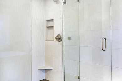 Bathroom - mid-sized transitional master beige tile and porcelain tile bathroom idea in Seattle with a hinged shower door and a built-in vanity