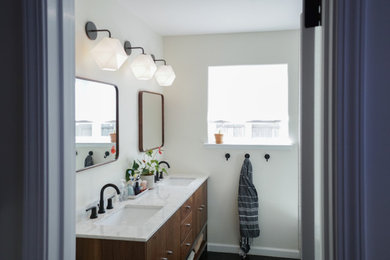 Bathroom - mid-sized mid-century modern master yellow tile and subway tile ceramic tile and black floor bathroom idea in San Francisco with medium tone wood cabinets, a one-piece toilet, white walls, an undermount sink, marble countertops, a hinged shower door and yellow countertops