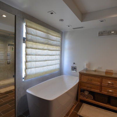 Example of a mid-sized minimalist master brown tile porcelain tile bathroom design in Los Angeles with beaded inset cabinets, medium tone wood cabinets, a two-piece toilet, white walls, a vessel sink and solid surface countertops