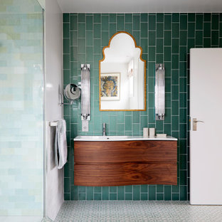 This is an example of a small contemporary master bathroom in London with flat-panel cabinets, brown cabinets, an undermount tub, an open shower, a one-piece toilet, green tile, porcelain tile, white walls, porcelain floors, a drop-in sink, green floor, an open shower, white benchtops, a double vanity and a floating vanity.