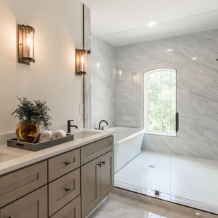 Large transitional master bathroom in Atlanta with shaker cabinets, brown cabinets, a freestanding tub, a double shower, a one-piece toilet, white tile, marble, white walls, mosaic tile floors, a drop-in sink, engineered quartz benchtops, white floor, a hinged shower door, white benchtops, a double vanity, a built-in vanity and brick walls.