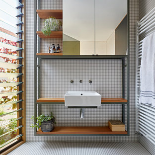 Inspiration for a scandinavian 3/4 bathroom in Melbourne with open cabinets, white tile, a wall-mount sink, wood benchtops, white floor and brown benchtops.
