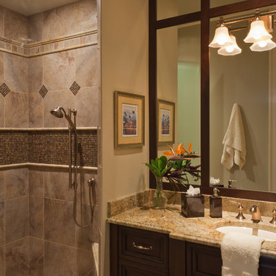 Inspiration for a mid-sized timeless 3/4 gray tile and porcelain tile porcelain tile and beige floor alcove shower remodel in Miami with granite countertops, an undermount sink, recessed-panel cabinets, dark wood cabinets and beige walls