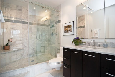 Inspiration for a mid-sized contemporary 3/4 gray tile, white tile and porcelain tile marble floor corner shower remodel in Chicago with flat-panel cabinets, dark wood cabinets, a one-piece toilet, white walls, an undermount sink and marble countertops