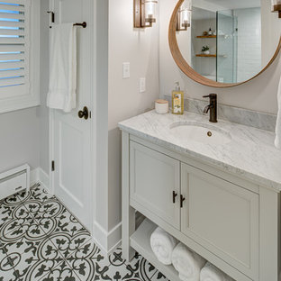 Example of a small cottage master white tile and subway tile cement tile floor and multicolored floor corner shower design in DC Metro with furniture-like cabinets, gray cabinets, a two-piece toilet, white walls, an undermount sink, marble countertops, a hinged shower door and white countertops
