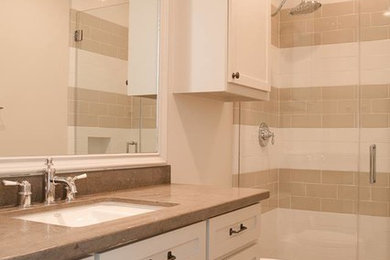 Photo of a medium sized classic shower room bathroom in Houston with recessed-panel cabinets, white cabinets, a corner shower, beige tiles, white tiles, metro tiles, beige walls, ceramic flooring, a submerged sink, engineered stone worktops, beige floors and a hinged door.