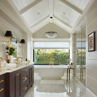 Photo of a mid-sized traditional master bathroom in Los Angeles with purple cabinets, a freestanding tub, white tile, marble, an undermount sink, marble benchtops, a hinged shower door, recessed-panel cabinets, an alcove shower, beige walls and white floor.