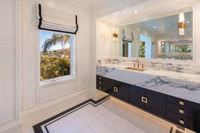 Example of a transitional white floor, single-sink and wall paneling bathroom design in Los Angeles with flat-panel cabinets, black cabinets, white walls, an undermount sink, white countertops and a floating vanity