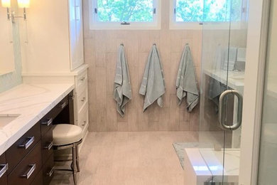 Example of a large minimalist master porcelain tile and gray floor bathroom design in Minneapolis with flat-panel cabinets, dark wood cabinets, a wall-mount toilet, an undermount sink, quartz countertops, a hinged shower door and white countertops