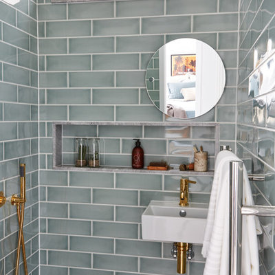 Example of a transitional master gray tile and ceramic tile wet room design in London with a wall-mount sink