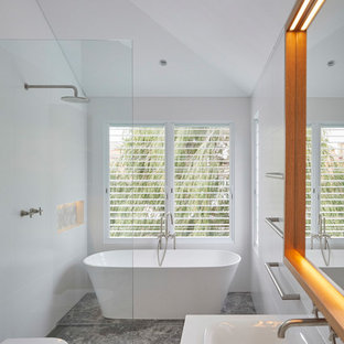 This is an example of a contemporary 3/4 wet room bathroom in Other with a freestanding tub, white walls, a drop-in sink, grey floor, an open shower and grey benchtops.