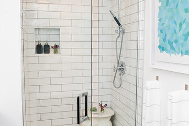 Alcove shower - mid-sized contemporary master black and white tile and cement tile cement tile floor alcove shower idea in Other with flat-panel cabinets, black cabinets, a one-piece toilet, white walls, an undermount sink and quartzite countertops