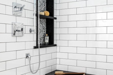 Inspiration for a transitional 3/4 white tile and ceramic tile cement tile floor bathroom remodel in Providence with recessed-panel cabinets, white cabinets, a two-piece toilet, green walls, a vessel sink, quartzite countertops and black countertops