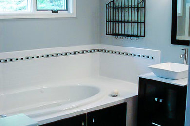This is an example of a large contemporary ensuite bathroom in Other with black cabinets, a built-in bath, an alcove shower, black and white tiles, ceramic tiles, grey walls, mosaic tile flooring, a vessel sink, marble worktops and glass-front cabinets.