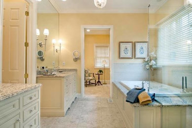 Inspiration for a large traditional ensuite bathroom in Columbus with a submerged sink, beaded cabinets, beige cabinets, granite worktops, a built-in bath, a corner shower, a two-piece toilet, white tiles, ceramic tiles, yellow walls and porcelain flooring.