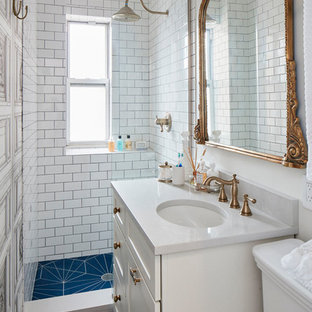 Small eclectic 3/4 white tile and ceramic tile ceramic tile and blue floor bathroom photo in New York with shaker cabinets, white cabinets, a two-piece toilet, white walls, an undermount sink, quartz countertops and gray countertops