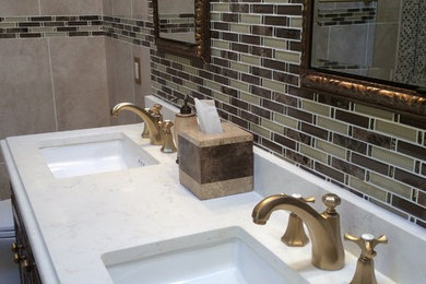 Corner shower - mid-sized eclectic master beige tile and ceramic tile ceramic tile and beige floor corner shower idea in New York with raised-panel cabinets, dark wood cabinets, quartz countertops, an undermount tub, a two-piece toilet, beige walls, an undermount sink and a hinged shower door