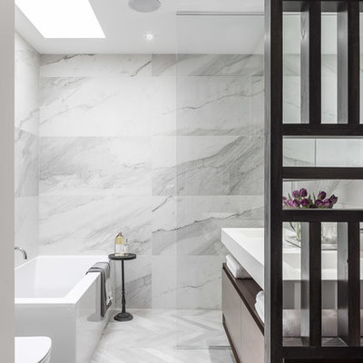 Example of a small minimalist master gray tile and porcelain tile porcelain tile bathroom design in Ottawa with flat-panel cabinets, dark wood cabinets, a two-piece toilet, white walls and an integrated sink