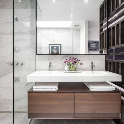 Example of a small minimalist master gray tile and porcelain tile porcelain tile bathroom design in Ottawa with flat-panel cabinets, dark wood cabinets, a two-piece toilet, white walls and an integrated sink