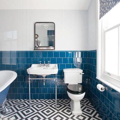 Inspiration for a small timeless blue tile and ceramic tile ceramic tile and multicolored floor corner shower remodel in Sussex with a one-piece toilet, white walls, a pedestal sink and a hinged shower door