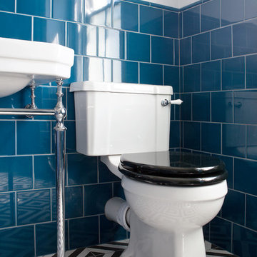 Blue-tiled main bathroom with slipper bath and geometric flooring - Hove