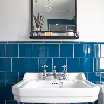 Blue-tiled main bathroom with slipper bath and geometric flooring - Hove