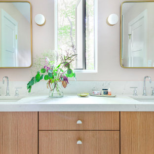 Mid-sized transitional kids' white tile and mosaic tile gray floor corner shower photo in Chicago with flat-panel cabinets, light wood cabinets, a two-piece toilet, pink walls, an undermount sink, quartz countertops, a hinged shower door and white countertops