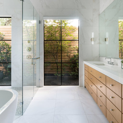 Inspiration for a large contemporary master white tile and marble tile white floor and marble floor bathroom remodel in Dallas with flat-panel cabinets, medium tone wood cabinets, white walls, an undermount sink, a hinged shower door, white countertops and solid surface countertops