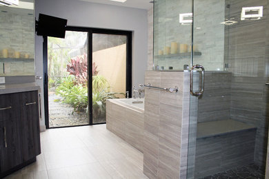Example of a large minimalist master gray tile and stone tile porcelain tile and gray floor bathroom design in Miami with flat-panel cabinets, gray cabinets, a one-piece toilet, beige walls, an undermount sink, terrazzo countertops and a hinged shower door