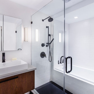 Inspiration for a mid-sized modern master white tile and subway tile porcelain tile bathroom remodel in New York with a vessel sink, flat-panel cabinets, dark wood cabinets, concrete countertops, a wall-mount toilet and white walls