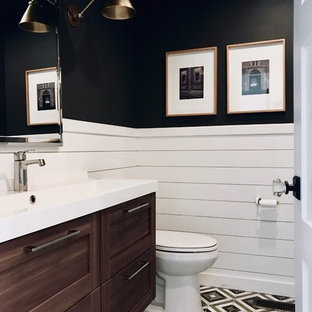 Example of a small trendy mosaic tile floor bathroom design in Columbus with shaker cabinets, dark wood cabinets, a two-piece toilet, black walls, an integrated sink, solid surface countertops and white countertops