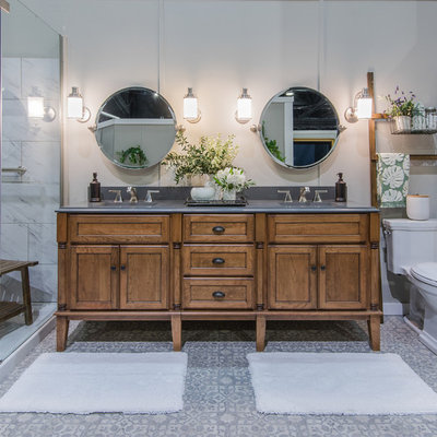 Example of an island style black and white tile mosaic tile floor and gray floor corner shower design in Providence with shaker cabinets, medium tone wood cabinets, gray walls and a hinged shower door