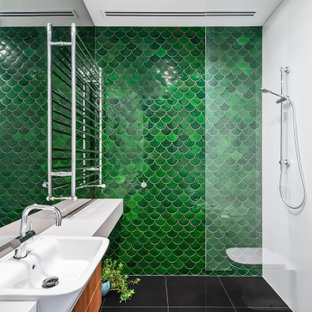 Photo of an expansive contemporary bathroom in Melbourne with flat-panel cabinets, medium wood cabinets, a curbless shower, green tile, a vessel sink, black floor, an open shower, white benchtops, a single vanity and a floating vanity.