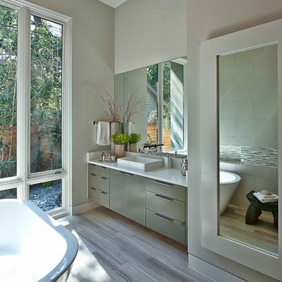 Trendy freestanding bathtub photo in Austin with a vessel sink