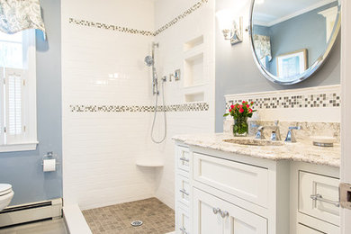 Mid-sized elegant 3/4 beige tile and mosaic tile vinyl floor doorless shower photo in Boston with shaker cabinets, white cabinets, a two-piece toilet, gray walls, an undermount sink and granite countertops