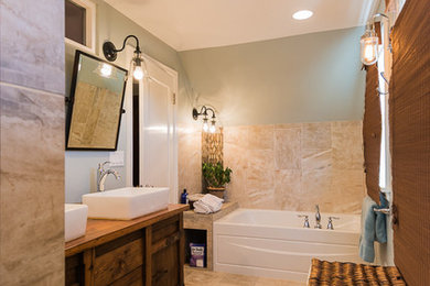 Inspiration for a large country master beige tile and porcelain tile beige floor and porcelain tile bathroom remodel in Portland with green walls, a two-piece toilet, a vessel sink, medium tone wood cabinets, wood countertops, a hinged shower door and flat-panel cabinets