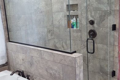 Example of a mid-sized transitional master gray tile and porcelain tile porcelain tile and gray floor bathroom design in Grand Rapids with a hinged shower door