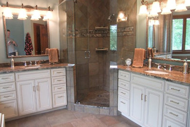 Inspiration for a medium sized classic ensuite bathroom in Cleveland with recessed-panel cabinets, white cabinets, beige tiles, porcelain tiles, granite worktops, a built-in bath, a corner shower, a two-piece toilet, grey walls, porcelain flooring and a submerged sink.